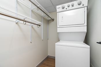A white oven and dryer in a small laundry room.